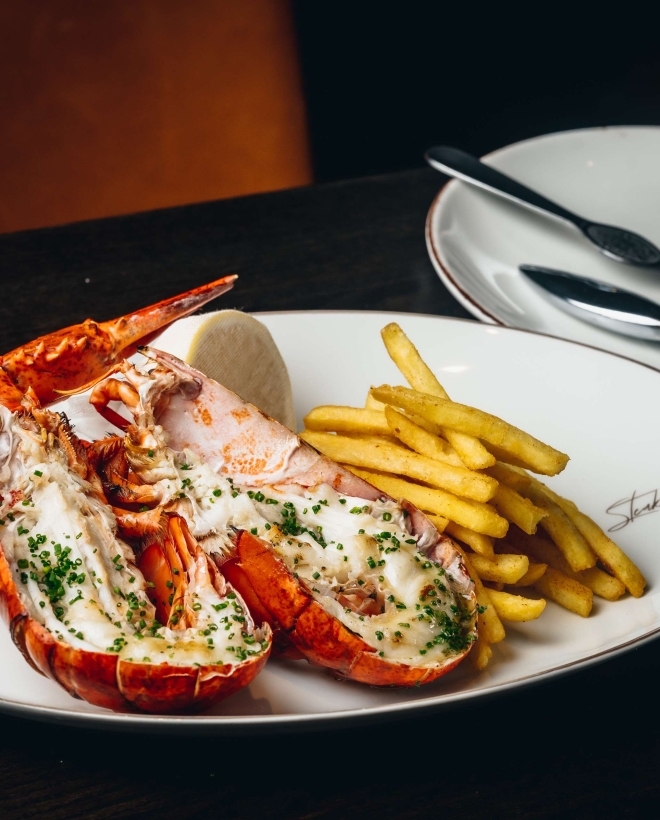 Lobster and fries on a white serving plate